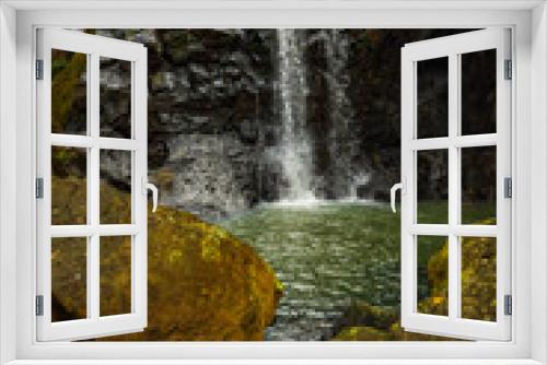 Fototapeta Naklejka Na Ścianę Okno 3D - Waterfall landscape. Beautiful hidden waterfall in tropical rainforest. Foreground with big stones. Fast shutter speed. Sing Sing Angin waterfall, Bali, Indonesia