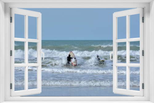 Fototapeta Naklejka Na Ścianę Okno 3D - People practising sport in the waves on a beach of Brittany. France