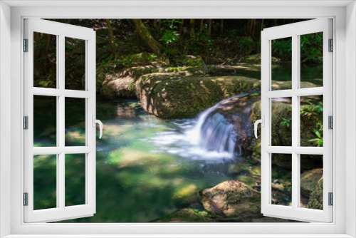 Fototapeta Naklejka Na Ścianę Okno 3D - Clear stream that flows through the rocks. Falling into the Emerald Pool, Erawan Kanchanaburi, Thailand.