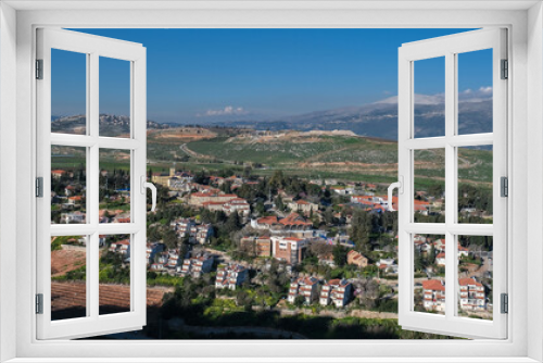 View of the town of Metula, situated on the Israeli-Lebanese border, at the foot of Mount Hermon (in the background), as seen from Dado lookout point, Upper Galilee, Israel.