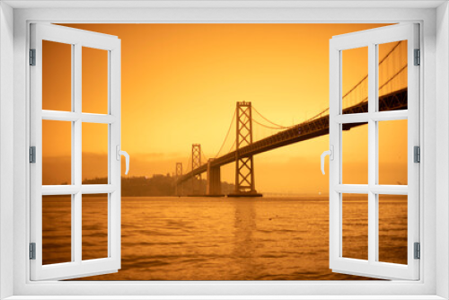Fototapeta Naklejka Na Ścianę Okno 3D - San Francisco Bay bridge and Yerba Buena island under orange ominous sky with fire smoked tinted sky bay bridge Oakland san Francisco Bridge 