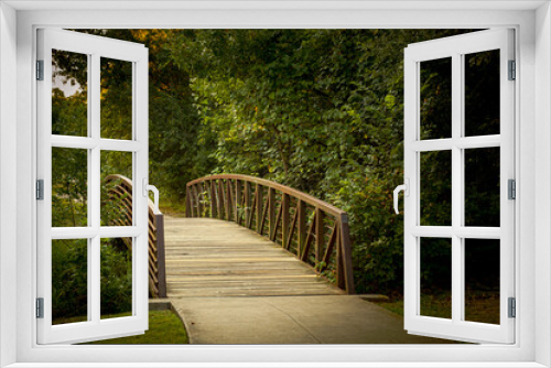 Fototapeta Naklejka Na Ścianę Okno 3D - Rustic iron bridge walking path on fall day