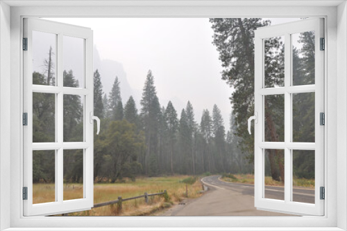 Fototapeta Naklejka Na Ścianę Okno 3D - Very hazy and smokey view of mountains and trees from Yosemite Valley, during wildfire season