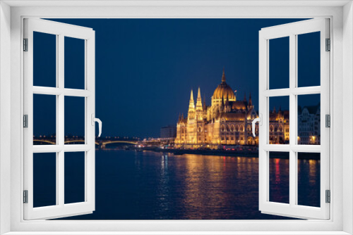 Fototapeta Naklejka Na Ścianę Okno 3D - Hungarian Parliament and bridge in Budapest. Night illumination at blue background. Amazing landmark in Europe, Hungary.