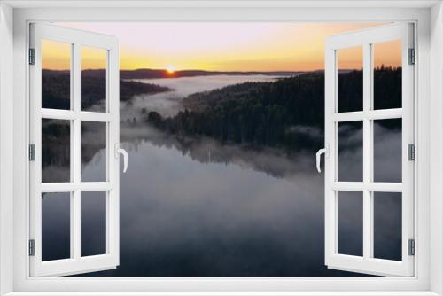 Fototapeta Naklejka Na Ścianę Okno 3D - Sunrise on the lake with fog. Panorama view from a height of flight on a drone.