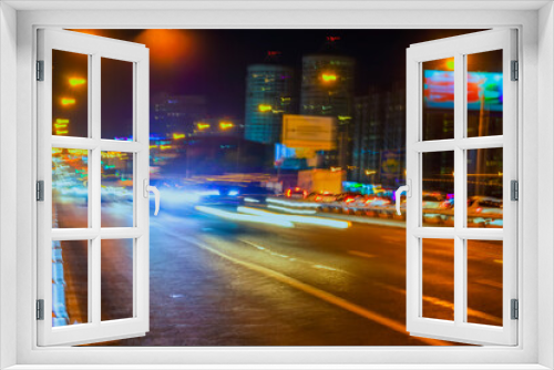 Fototapeta Naklejka Na Ścianę Okno 3D - Abstract blurred image of urban street night traffic, bright city bokeh lights, night time, for background. Traffic, transportation concept