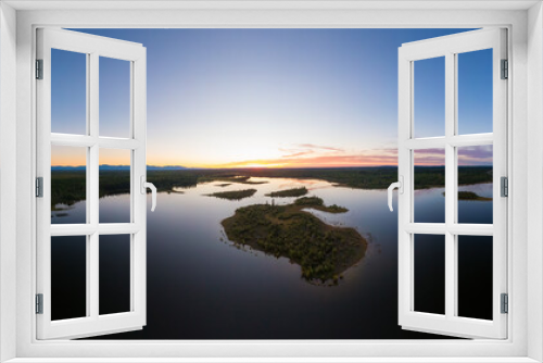 Fototapeta Naklejka Na Ścianę Okno 3D - Picturesque Aerial View of Canadian Scenic Island surrounded by Peaceful Lakes. Vibrant summer sunset on the horizon. Cariboo Highway, Interior British Columbia.
