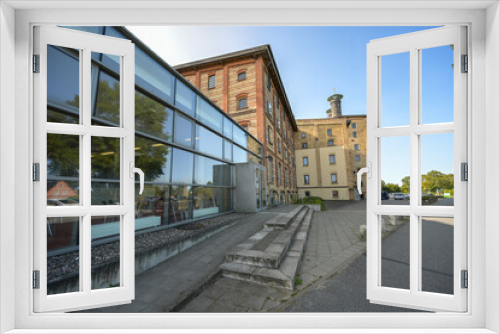 Fototapeta Naklejka Na Ścianę Okno 3D - Historic malt factory in Grevesmuehlen, today the building of yellow bricks is an industrial monument and contains some offices of the district administration Northwest Mecklenburg, Germany