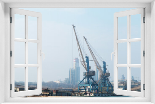 Fototapeta Naklejka Na Ścianę Okno 3D - Harbor crane. Two old rusty cranes in an industrial port in the fog.