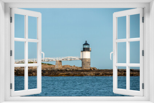 Fototapeta Naklejka Na Ścianę Okno 3D - White and stone lighthouse by the ocean in Maine United States