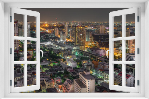 Fototapeta Naklejka Na Ścianę Okno 3D - Aerial view of the modern buildings and skyscrapers at night of Baiyoke Tower, Ratchaprarop Road in the Ratchathewi district of Bangkok City, Thailand.