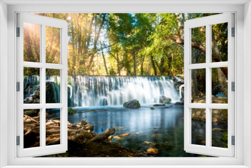 Fototapeta Naklejka Na Ścianę Okno 3D - Natural waterfall called “Cascada del Hervidero” in Madrid, in the forest, with sunlight between vegetation and rocks. 
