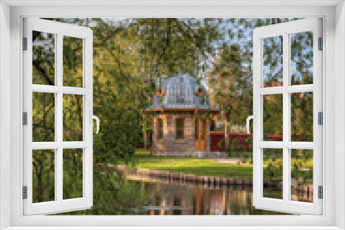Fototapeta Naklejka Na Ścianę Okno 3D - garden pavilion among the trees reflecting in the water