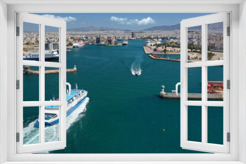 Fototapeta Naklejka Na Ścianę Okno 3D - Aerial drone photo of passenger ferry cruising in high speed and entering famous port of Piraeus, Attica, Greece
