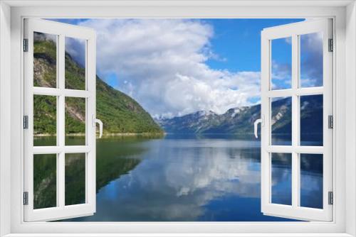 Fototapeta Naklejka Na Ścianę Okno 3D - reflection of the sky and mountains in the blue water of the fjord - Eidfjord