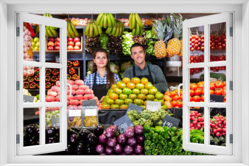 Fototapeta Naklejka Na Ścianę Okno 3D - Portrait of young man and woman offering greens and vegetables in supermarket