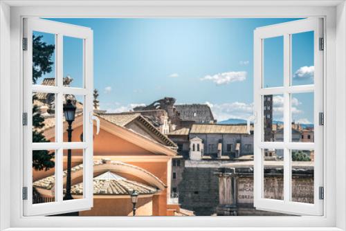 Fototapeta Naklejka Na Ścianę Okno 3D - View of an ancient church and roman ruins from the Campidoglio palace, seat of the city hall of Rome. Skyline of Rome with roman ancient arch and colosseum on the background Postcard from italy