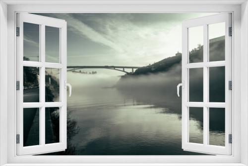 Fototapeta Naklejka Na Ścianę Okno 3D - View on Douro river and the bridge from seafront at misty early morning