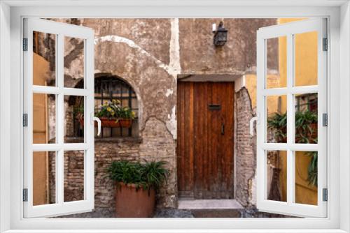 Fototapeta Naklejka Na Ścianę Okno 3D - Rome Italy, picturesque house front with natural wood door and window