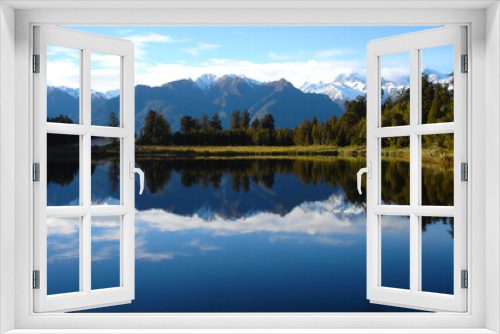 Fototapeta Naklejka Na Ścianę Okno 3D - Mirrored lake with snow capped mountains in New Zealand, luxury travel, adventure, wild travel, great outdoors, grasslands, wetlands