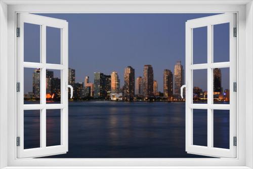 Fototapeta Naklejka Na Ścianę Okno 3D - New York, NY, USA - June 27, 2019: Night view to Long Island City and Gantry Plaza State Park from Manhattan