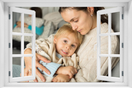 Mother and child, blond boy, lying on the couch at home