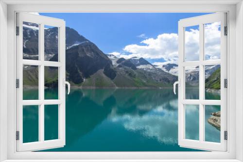 Fototapeta Naklejka Na Ścianę Okno 3D - Beautiful view of high mountain lake near Kaprun.Hike to the Mooserboden dam in Austrian Alps.Quiet relaxation in nature.Wonderful nature landscape,turquoise tranquil lake,holiday travel scene.