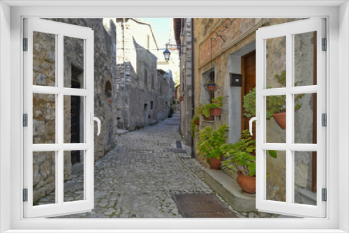 Fototapeta Naklejka Na Ścianę Okno 3D - A narrow street between the old houses of Fumone, a medieval village in the province of Frosinone, Italy.