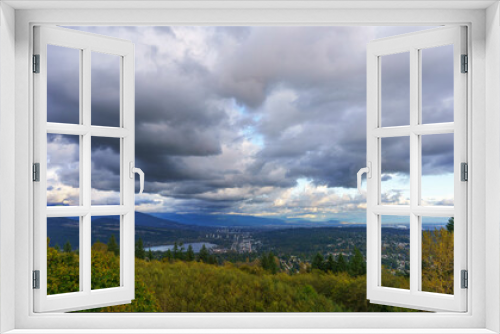 Fototapeta Naklejka Na Ścianę Okno 3D - Cloudy Fraser Valley with views of Port Moody at Burrard Inlet, trees in foreground and distant mountains