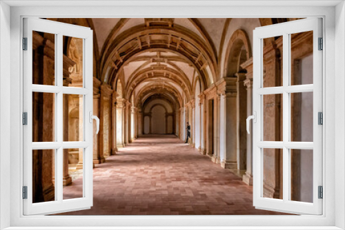 Fototapeta Naklejka Na Ścianę Okno 3D - Side-lit Cloister Hallway With Columns And Ribbed Vaulted Ceilings. Templar Castle/Convent Of Christ, Tomar, Portugal.