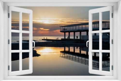 Fototapeta Naklejka Na Ścianę Okno 3D - Silhouettes of people and pier at sunset and calm sea water background