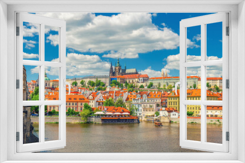 Panorama of Prague city historical centre with Prague Castle, St. Vitus Cathedral in Hradcany district, view from Charles Bridge Karluv Most across Vltava river. Blue sky white clouds, Czech Republic