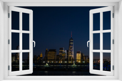 Fototapeta Naklejka Na Ścianę Okno 3D - View of skyscrapers along Hudson River in financial district of Manhattan. Skyline of downtown Manhattan at night