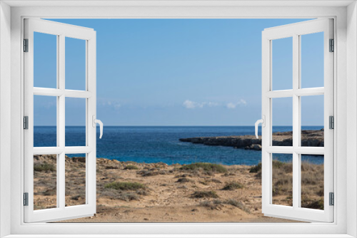 Fototapeta Naklejka Na Ścianę Okno 3D - Rocky beach of Mediterranean Sea near the Cavo Greco cape on Cyprus, Agia Napa. Bright sunny day with cloudless sky
