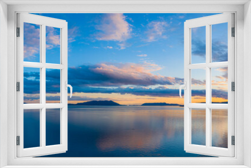 Fototapeta Naklejka Na Ścianę Okno 3D - Sunset Over Orcas Island in the Salish Sea and the San Juan Island Archipelago. Beautiful and dramatic sunset with colorful clouds and a calm sea in the Pacific Northwest.