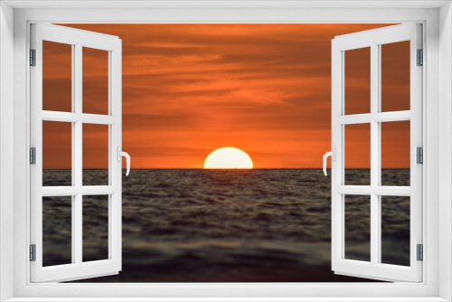 Fototapeta Naklejka Na Ścianę Okno 3D -  a beautiful sunset on a calm sea with a clear evening sky