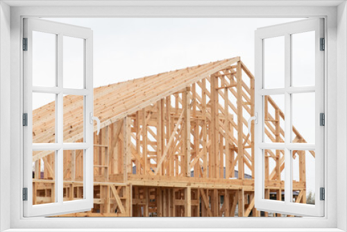 Fototapeta Naklejka Na Ścianę Okno 3D - Wooden frame house on construction site