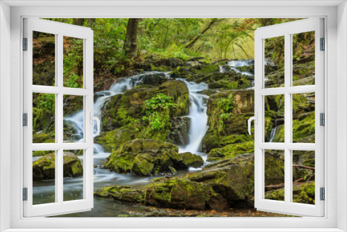 Fototapeta Naklejka Na Ścianę Okno 3D - Selke waterfall with rocks in the southern Harz. River in the Harz with moss-covered stones. Deciduous trees and ferns on the riverside with seasonal colored leaves