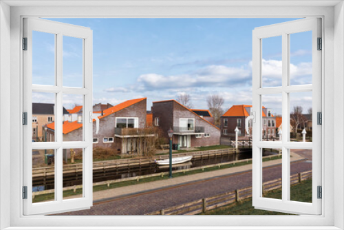 Fototapeta Naklejka Na Ścianę Okno 3D - Modern residential buildings, canal and bridge in Hindeloopen, Netherlands, Europe