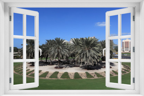 Fototapeta Naklejka Na Ścianę Okno 3D - Palm Trees at a roundabout in Dubai, UAE