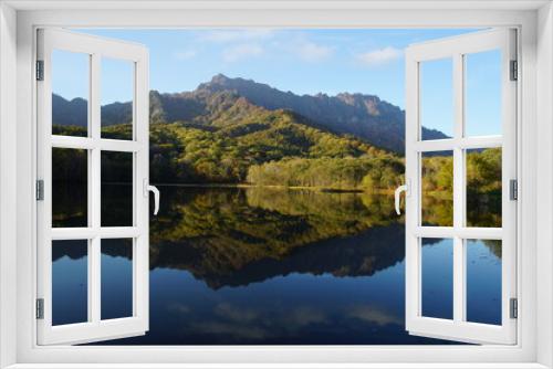 Fototapeta Naklejka Na Ścianę Okno 3D - A pond that reflects trees and mountains like a mirror. At dusk. Beautiful scenery of Japan.