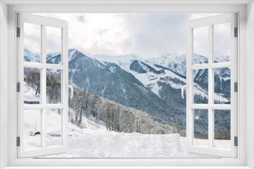 Fototapeta Naklejka Na Ścianę Okno 3D - View of the snow-covered mountains from Olympic village of Rosa Plateau at an altitude of 1170 m from sea level. Krasnaya Polyana, Sochi, Russia