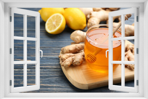 Fototapeta Naklejka Na Ścianę Okno 3D - Ginger and jar of honey on blue wooden table, space for text. Natural cold remedies