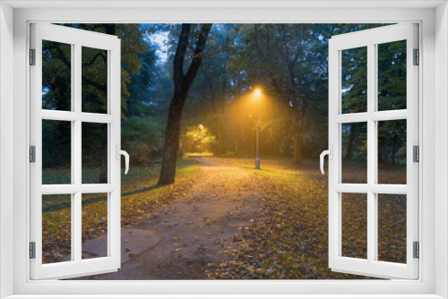 Fototapeta Naklejka Na Ścianę Okno 3D - Night view : landscape of alleyway with street lamps at misty night.
dark street illuminated with street lights. Romantic or dramatic atmosphere during dusk in autumn.
Beautiful background concept.