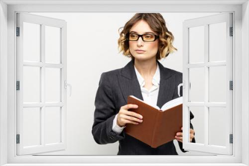 Business woman in a classic suit with a notebook in her hand and glasses on her face Copy Space