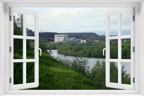 Fototapeta Naklejka Na Ścianę Okno 3D - landscape on the river and bridge with a view of the coal mine North of Russia