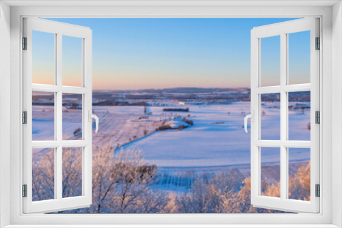 Fototapeta Naklejka Na Ścianę Okno 3D - Panorama view at a wintry countryside in sunset