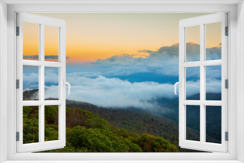 Fototapeta Naklejka Na Ścianę Okno 3D - Fog sits over the valley in the Blue Ridge Mountains of North Carolina at sunset.