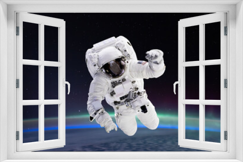 Fototapeta Naklejka Na Ścianę Okno 3D - Composite image of astronaut floating in space, earth planet in the background -  Elements of this image are furnished by NASA