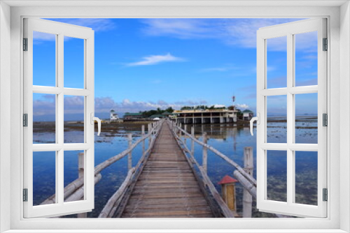 Fototapeta Naklejka Na Ścianę Okno 3D - A long wooden bridge leading to the island, Marine Sanctuary, Nalusuan Island, Cebu, Philippines